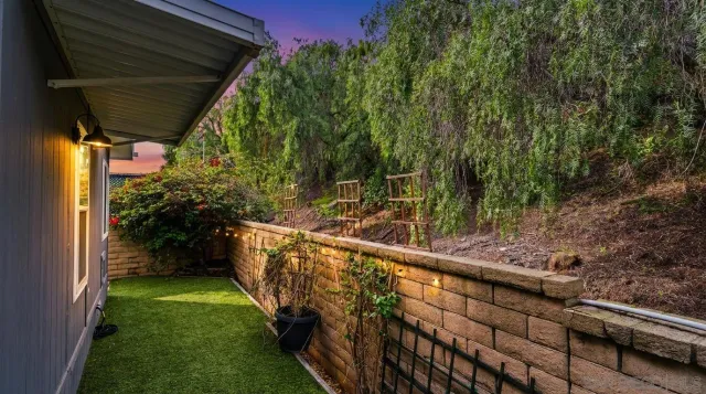 a view of a house with a swimming pool and a yard