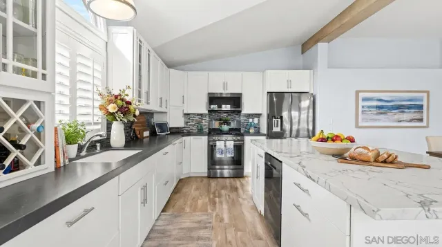 a kitchen with granite countertop lots of counter top space and stainless steel appliances
