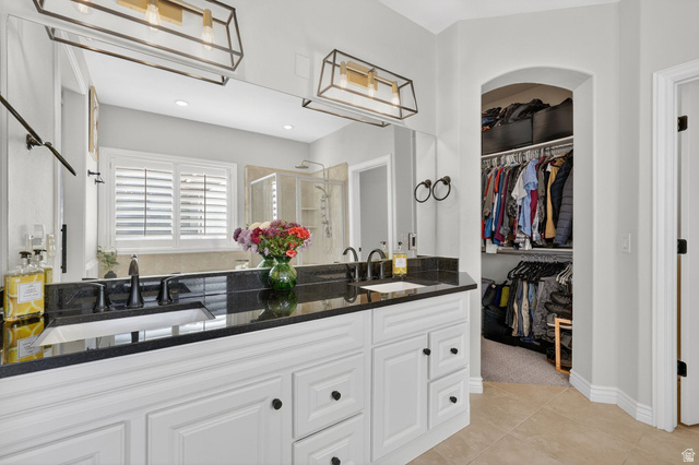 14738 Tangle Hill Road Herriman, UT 84096 - Photo 29 of 66 Double vanity with a dark countertop and undermount sinks