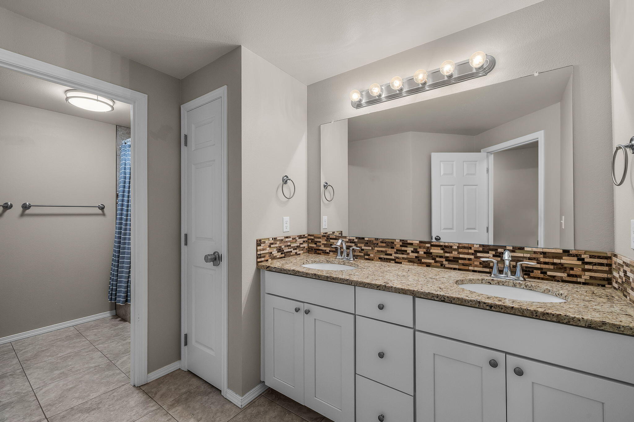 17064 Sacramento Road Bend, OR 97707 - Photo 27 of 50 a bathroom with a granite countertop sink and a mirror