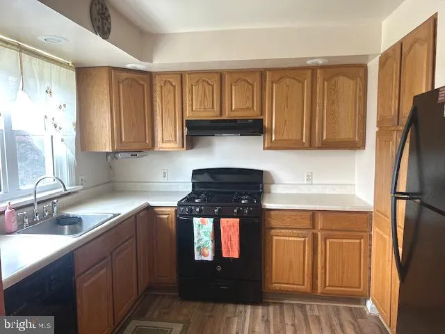 a kitchen with stainless steel appliances granite countertop a refrigerator stove and sink