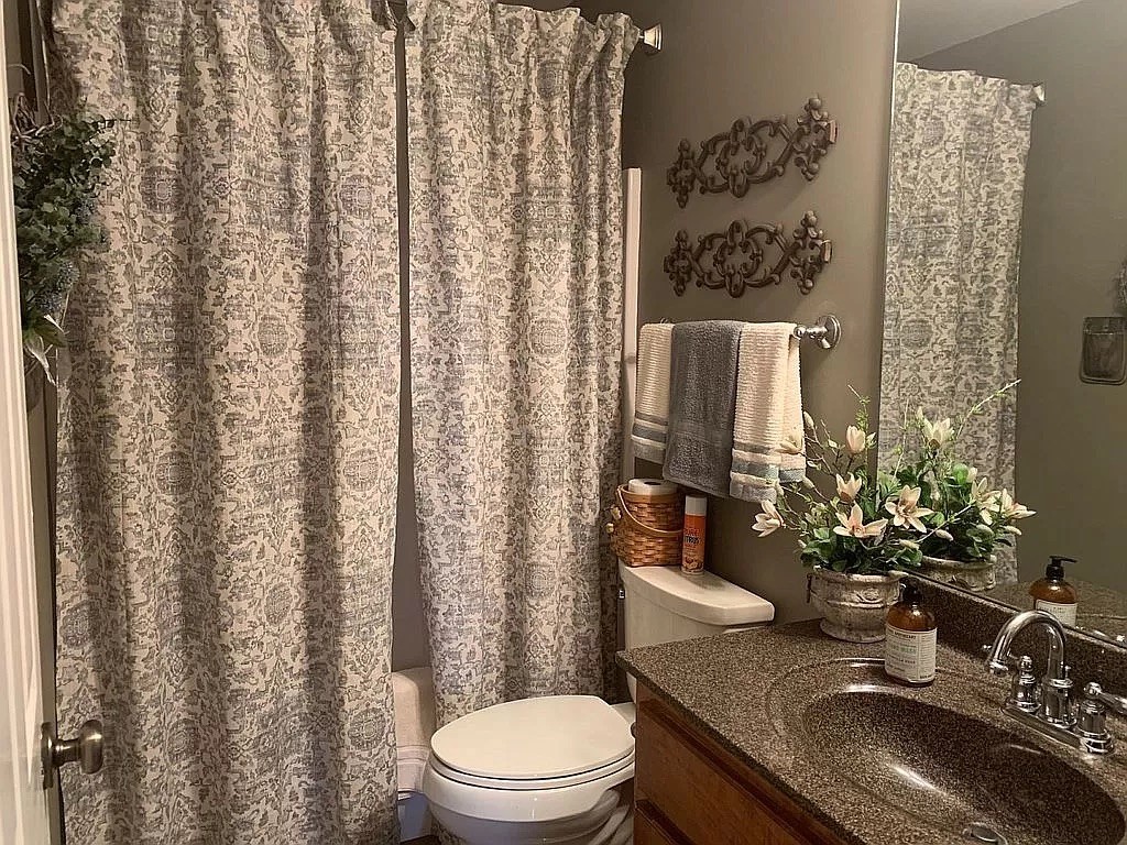 3685 South Hyde Road Springfield, TN 37172 - Photo 20 of 26 a bathroom with a granite countertop sink a toilet and a mirror