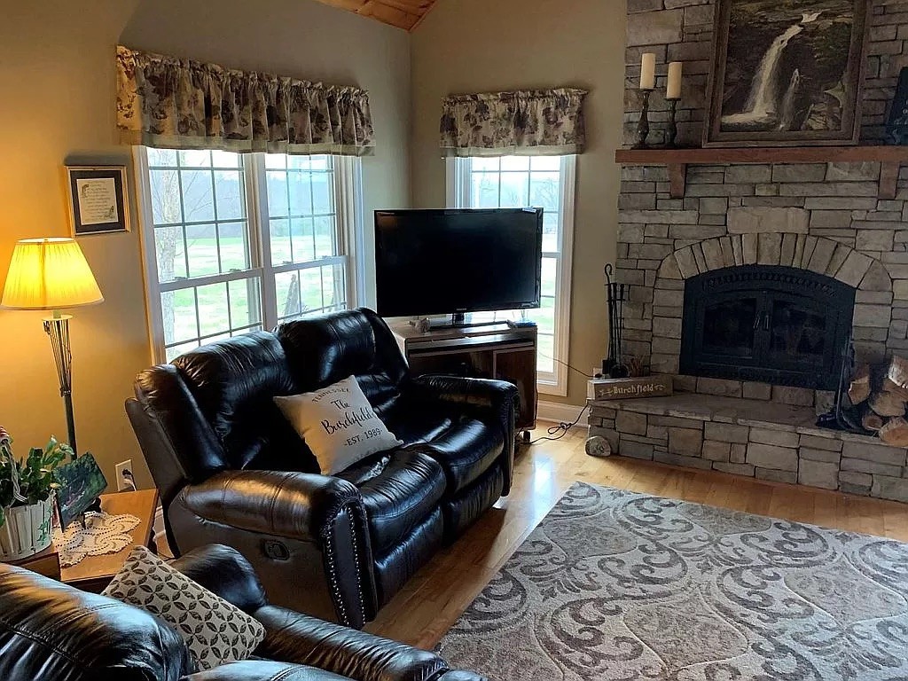 3685 South Hyde Road Springfield, TN 37172 - Photo 9 of 26 a living room with furniture a flat screen tv and a fireplace