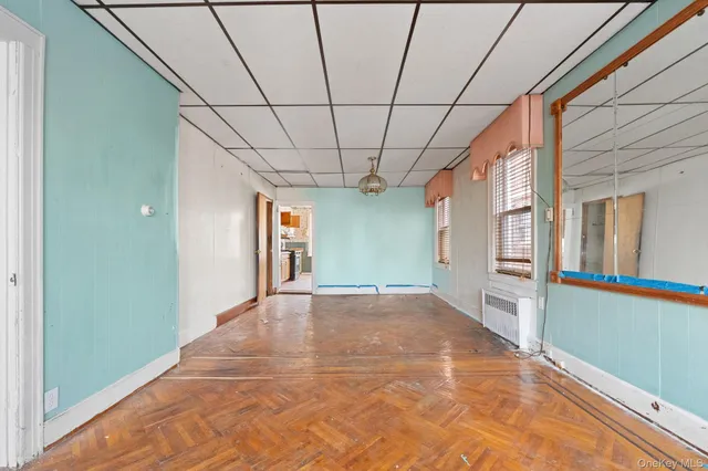 a view of empty room with cabinet and chandelier