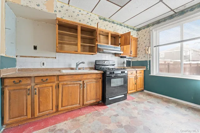 a kitchen with stainless steel appliances granite countertop a stove a sink dishwasher and a refrigerator