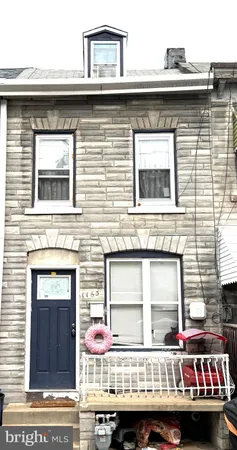 a view of a brick house with large windows