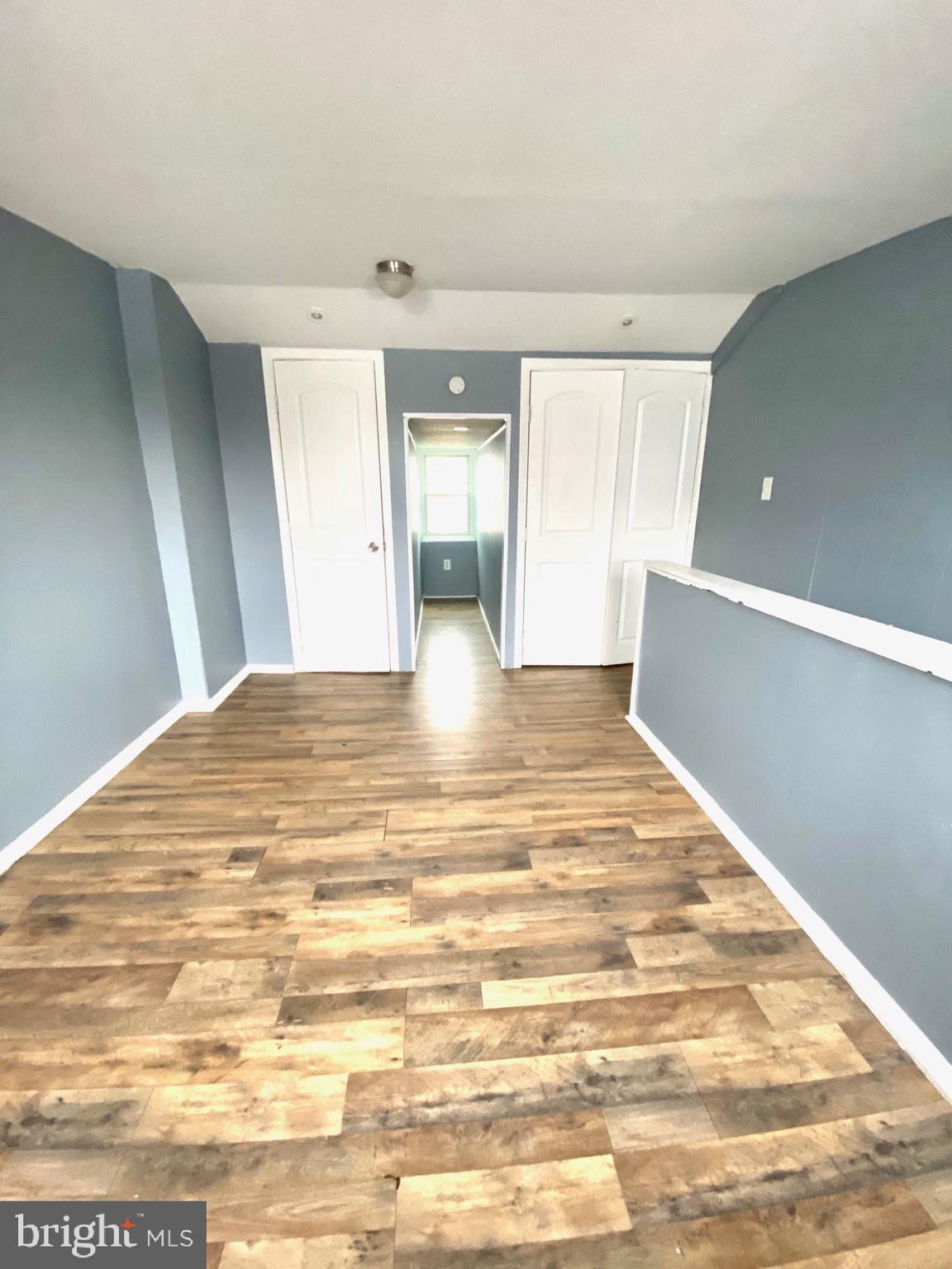 1163 Cotton Street Reading, PA 19602 - Photo 19 of 25 a view of an empty room with window and wooden floor