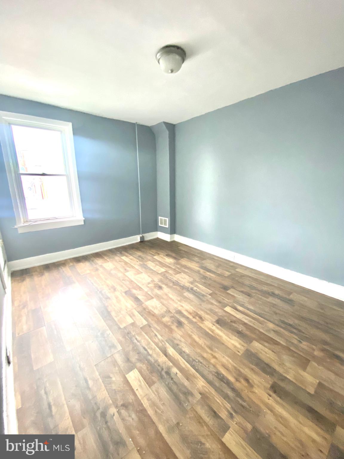 1163 Cotton Street Reading, PA 19602 - Photo 21 of 25 an empty room with wooden floor and windows