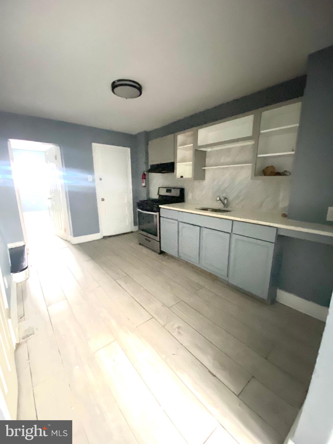 1163 Cotton Street Reading, PA 19602 - Photo 6 of 25 a large kitchen with kitchen island a sink stainless steel appliances and cabinets