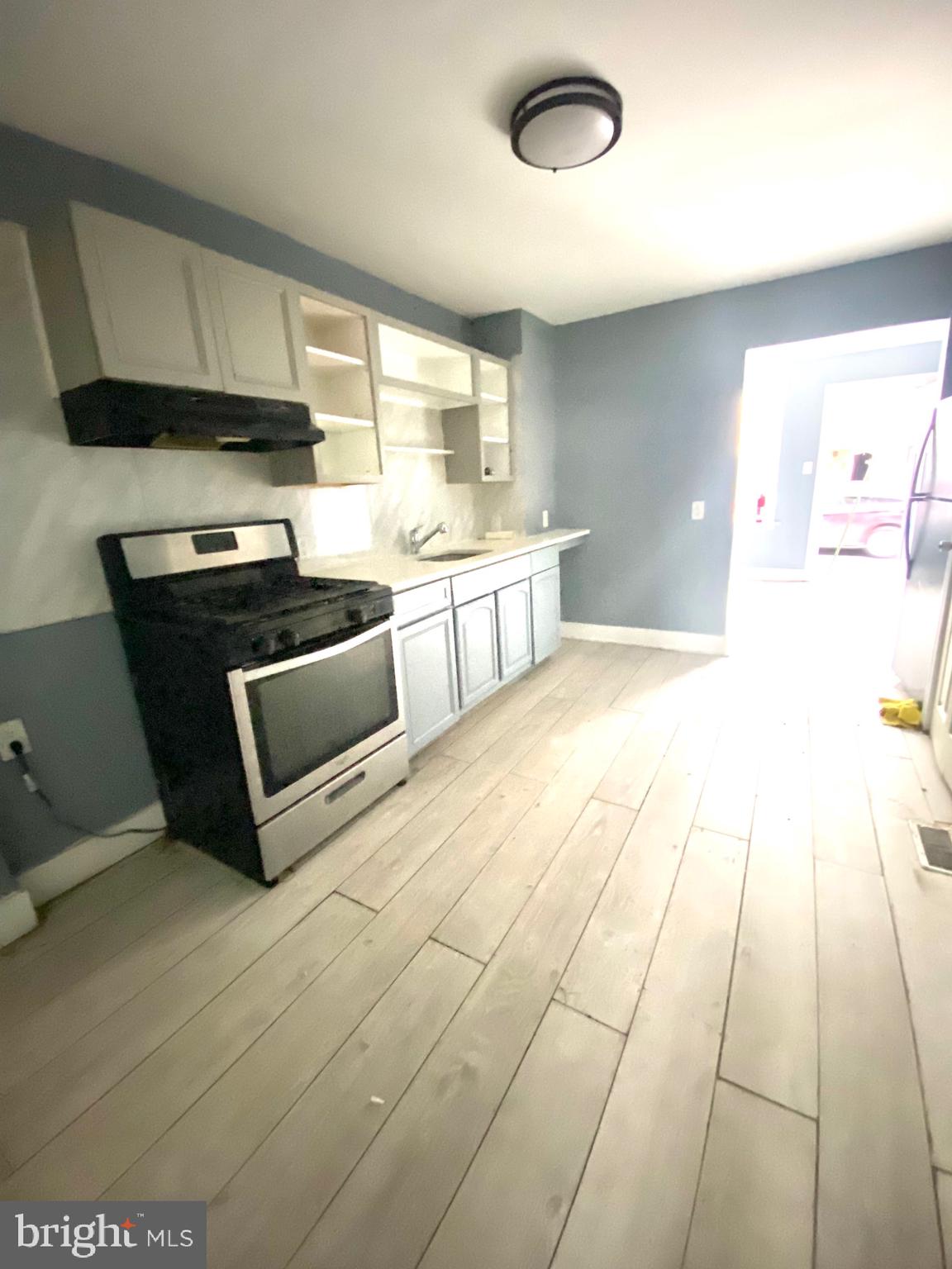 1163 Cotton Street Reading, PA 19602 - Photo 8 of 25 a kitchen with stainless steel appliances a stove a sink and a microwave