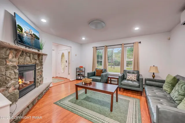 a living room with furniture and a fireplace