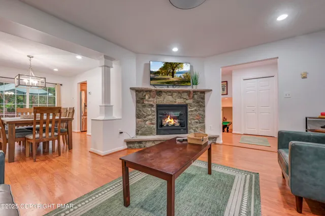 a living room with furniture a fireplace and a table