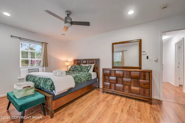 a bedroom with a bed and window