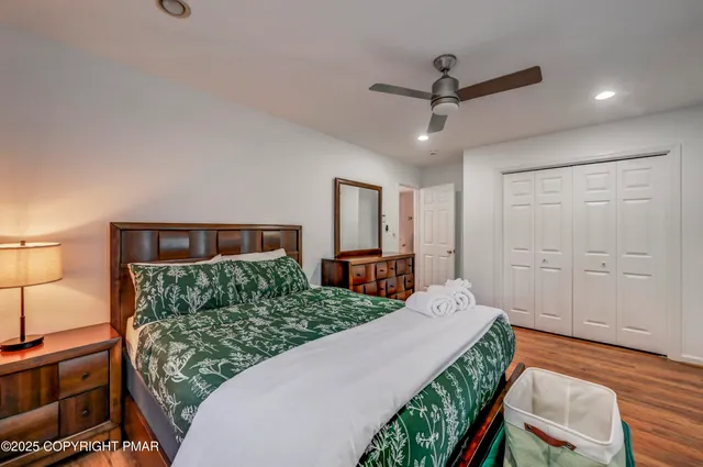 a bedroom with a large bed and a chandelier