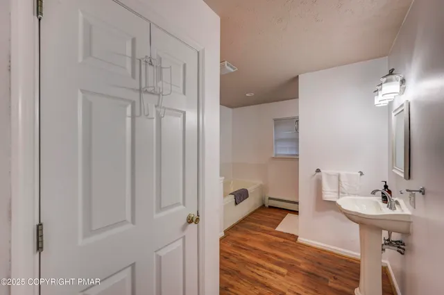 a bathroom with a bathtub and a shower