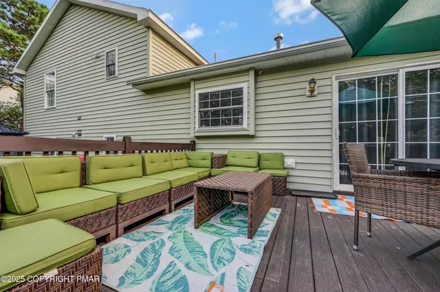 a view of a chairs and table on the wooden deck