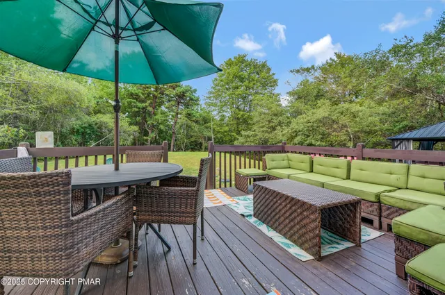 a view of a backyard with a tub and wooden fence