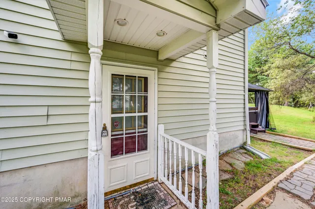 a backyard of a house with table and chairs