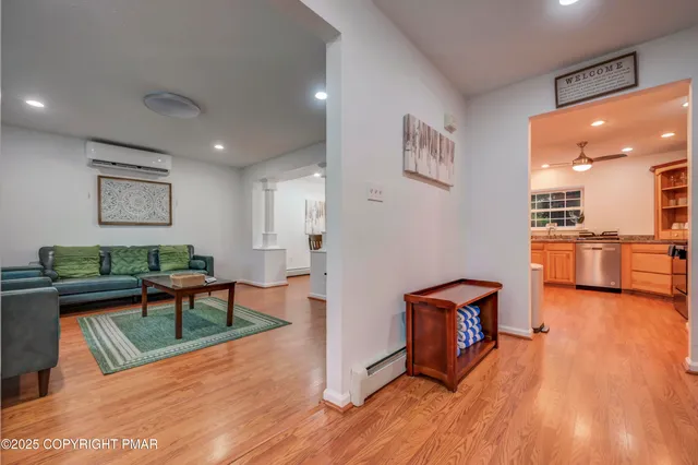 a living room with furniture and a wooden floor