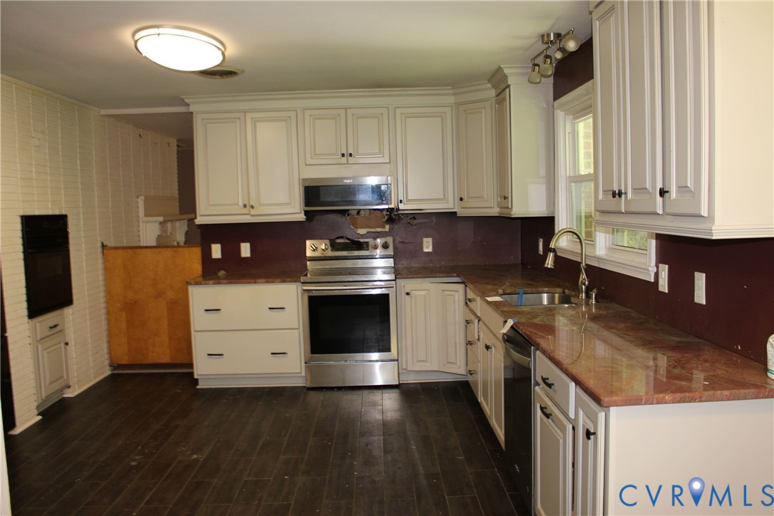 1645 Wilton Road Petersburg, VA 23805 - Photo 5 of 12 Kitchen featuring white cabinetry, stainless steel