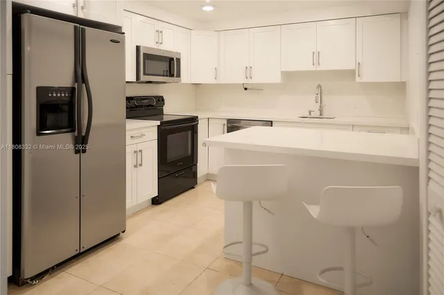 a living room with furniture tv and large windows