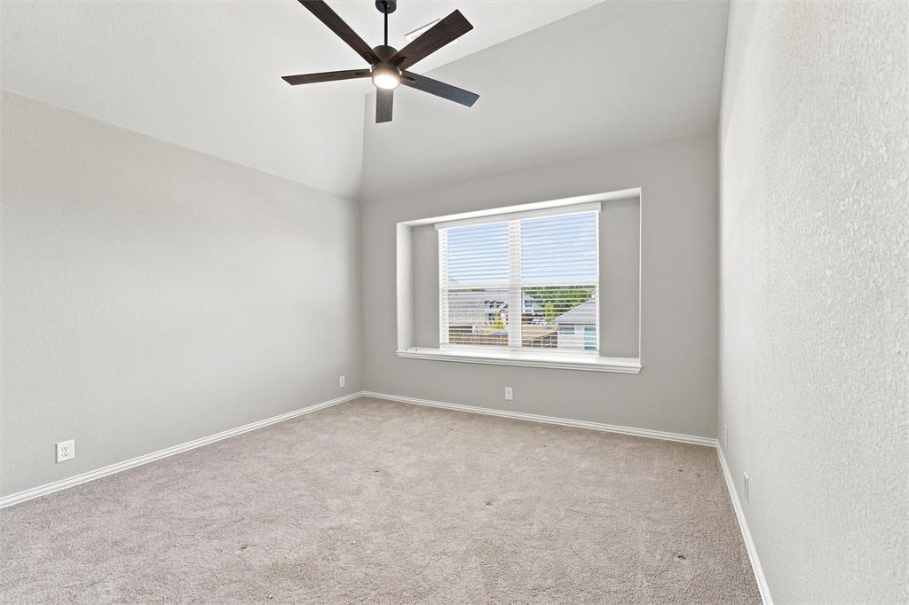 5225 Rowlan Row Midlothian, TX 76065 - Photo 29 of 33 Vaulted ceiling with a ceiling fan, neutral carpeting, and a window with blinds