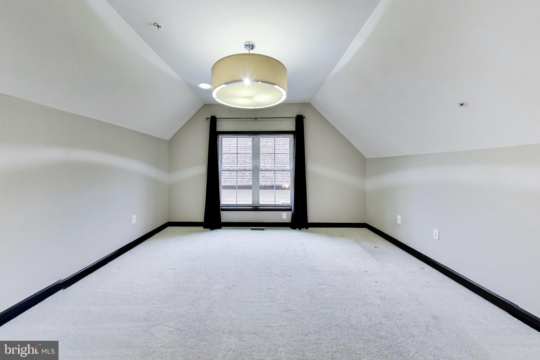 13513 Moonlight Trail Drive Silver Spring, MD 20906 - Photo 40 of 78 a view of an empty room with a window and wooden floor