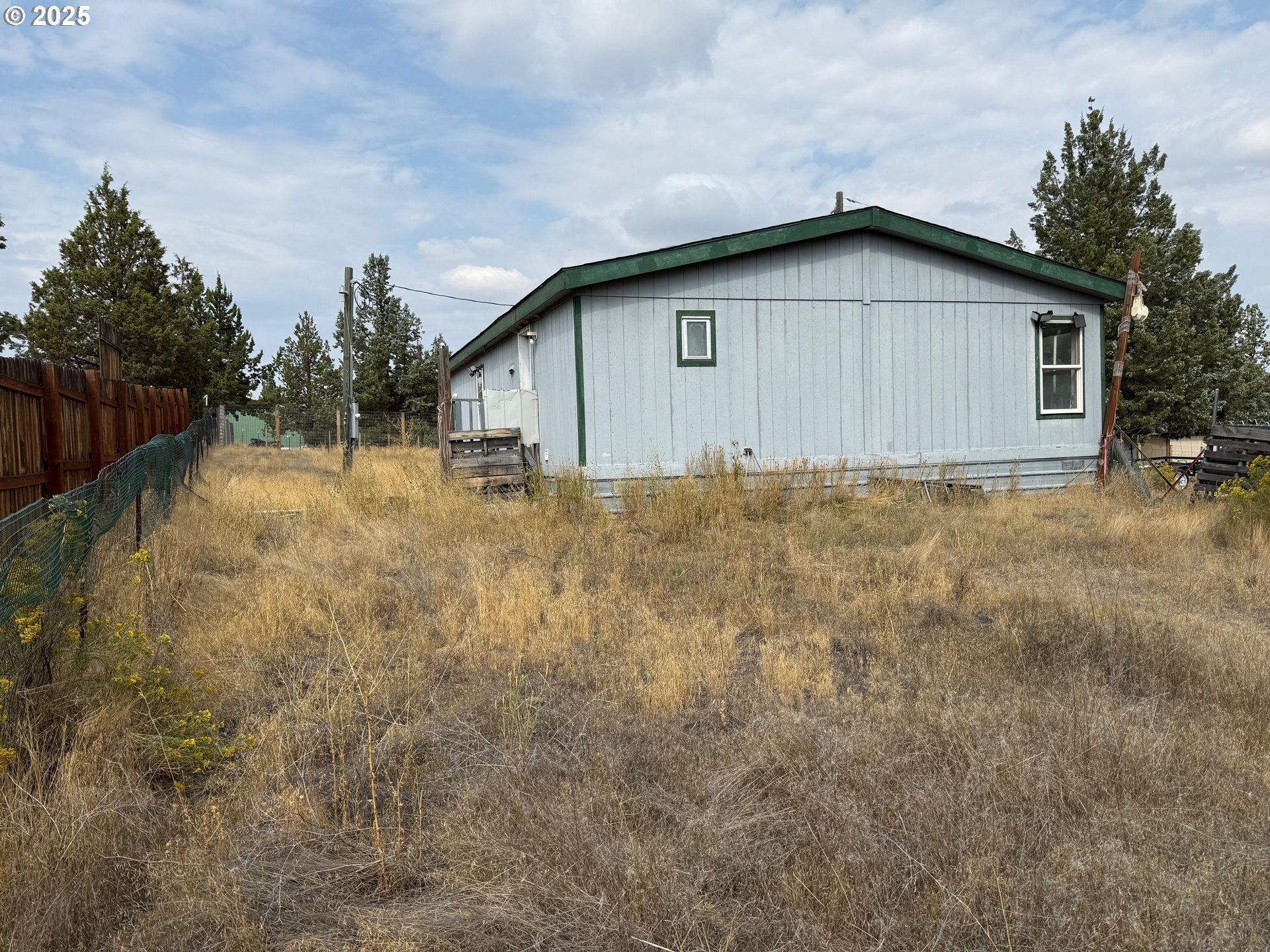 9071 Southwest Sand Ridge Road Terrebonne, OR 97760 - Photo 5 of 40 a view of a house with backyard and trees