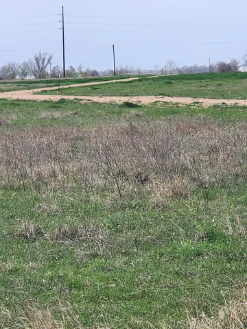 a view of a golf course with a big yard