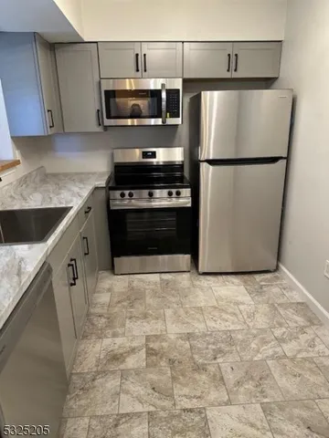 a kitchen with a refrigerator and a sink