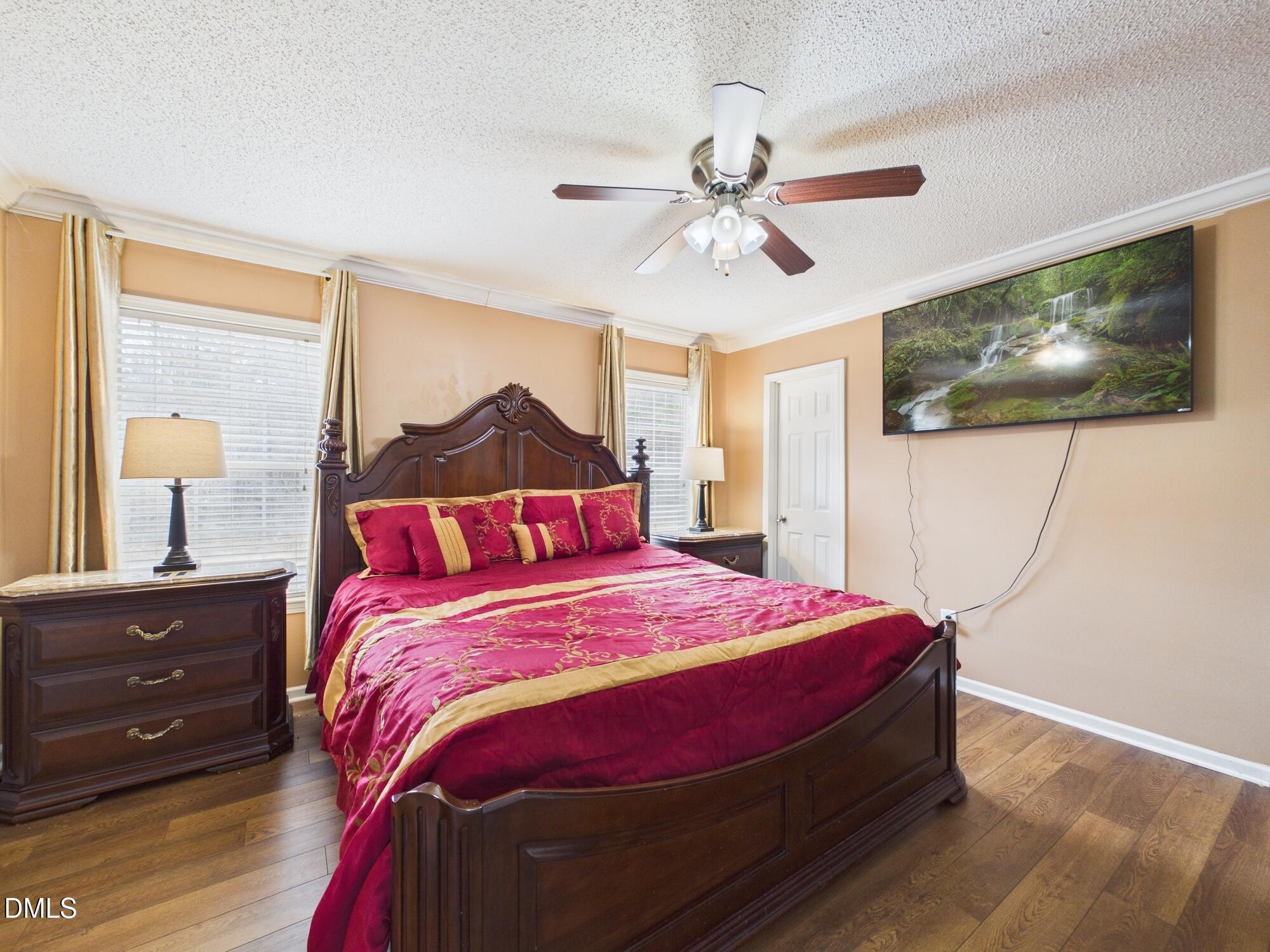 2528 Dalton Mill Road Bullock, NC 27507 - Photo 13 of 21 a bedroom with a bed and a chandelier