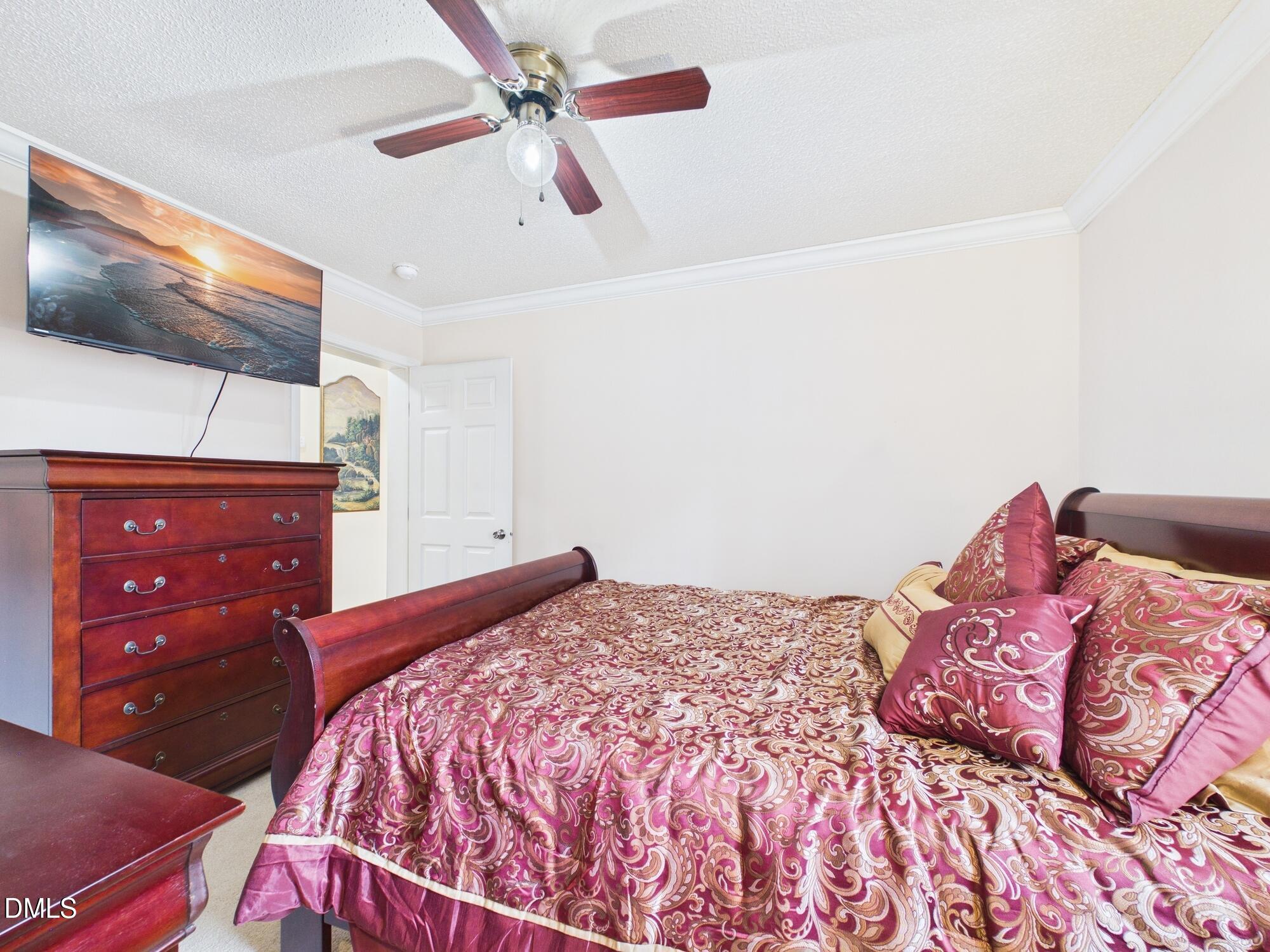 2528 Dalton Mill Road Bullock, NC 27507 - Photo 15 of 21 a bedroom with a bed and a flat screen tv