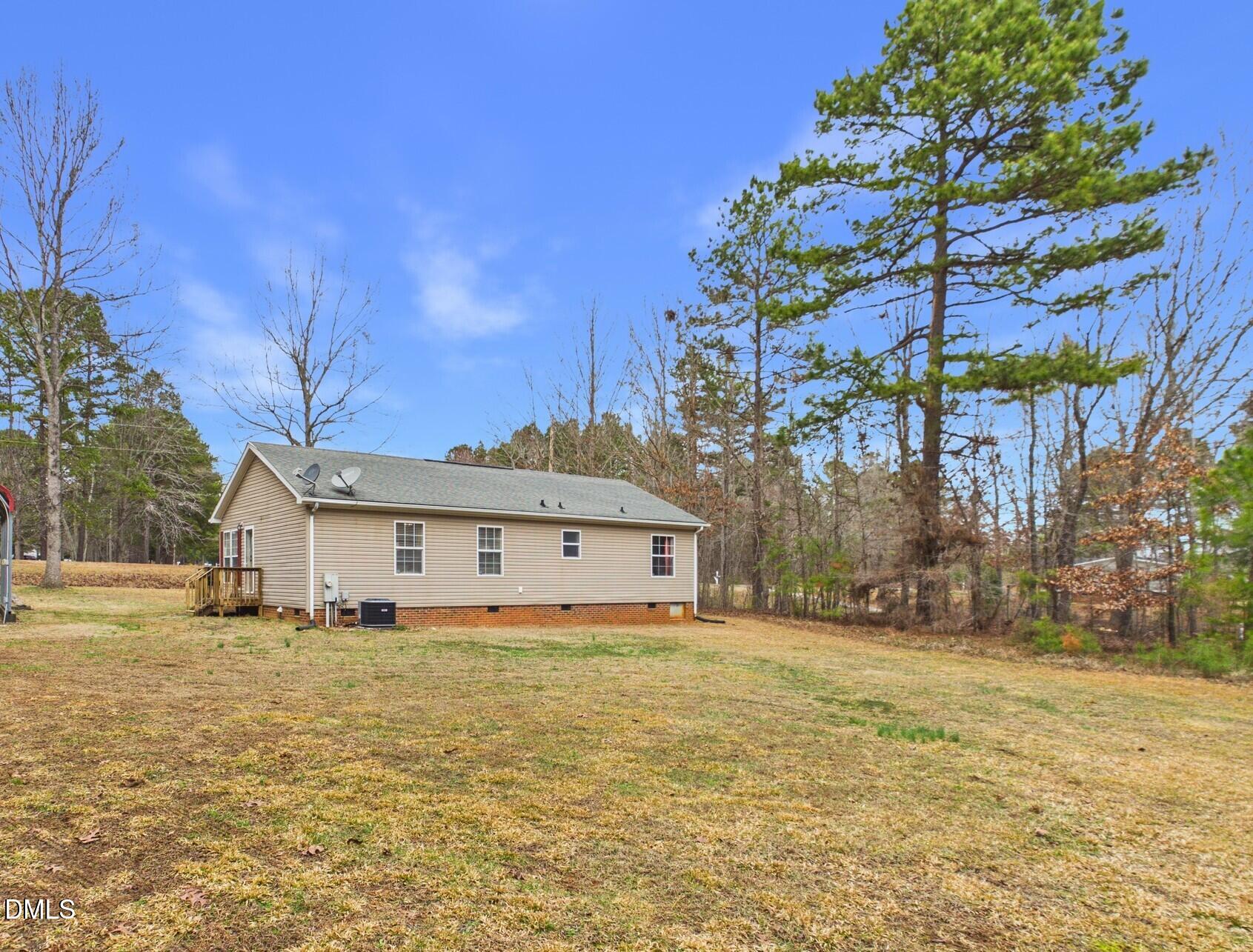 2528 Dalton Mill Road Bullock, NC 27507 - Photo 18 of 21 a view of a large pool with lawn chairs under an umbrella