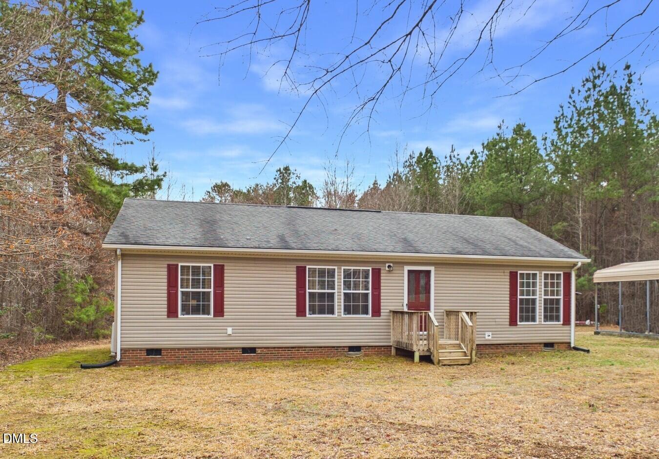 2528 Dalton Mill Road Bullock, NC 27507 - Photo 2 of 21 a front view of a house with a garden and yard