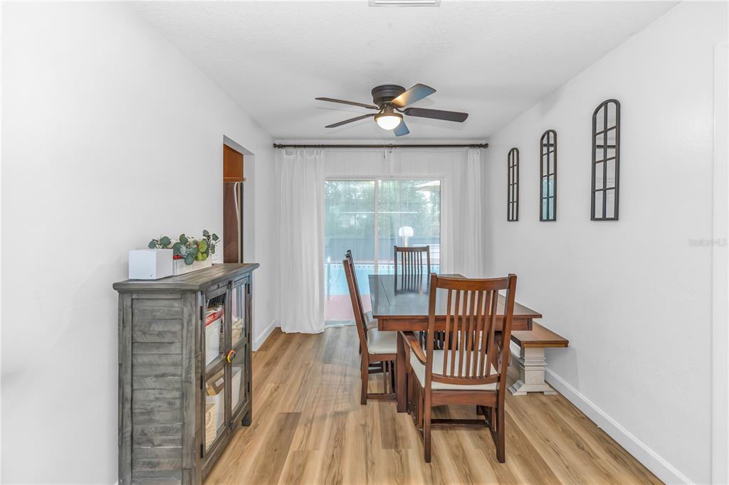 3137 Loblolly Street Deltona, FL 32725 - Photo 11 of 30 a view of a dining room with furniture wooden floor and a chandelier