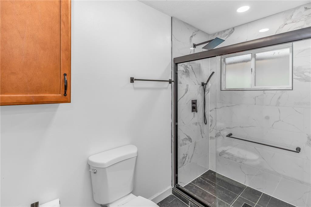 3137 Loblolly Street Deltona, FL 32725 - Photo 13 of 30 a bathroom with a toilet and a shower