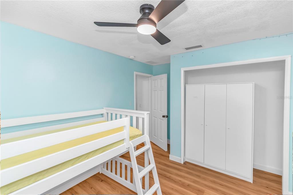 3137 Loblolly Street Deltona, FL 32725 - Photo 16 of 30 a bedroom with a bed and a chandelier