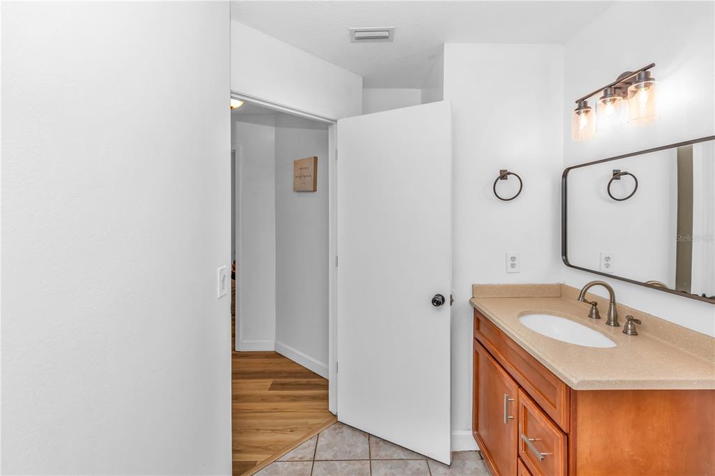 3137 Loblolly Street Deltona, FL 32725 - Photo 18 of 30 a bathroom with a sink and a mirror
