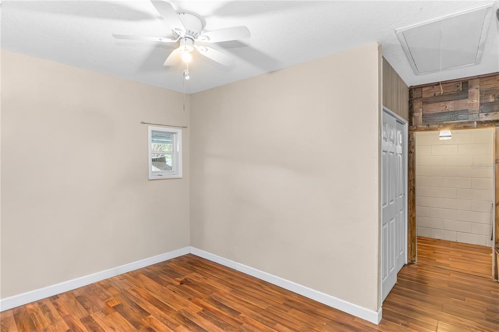 3137 Loblolly Street Deltona, FL 32725 - Photo 20 of 30 a view of a room with wooden floor and a ceiling fan