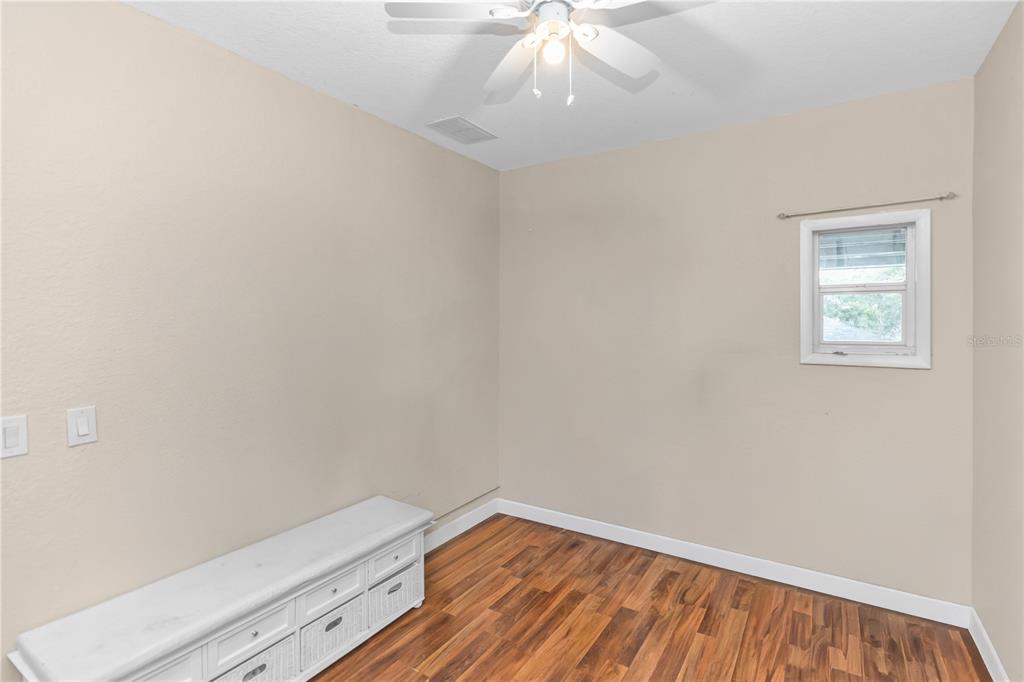 3137 Loblolly Street Deltona, FL 32725 - Photo 21 of 30 an empty room with wooden floor and fan