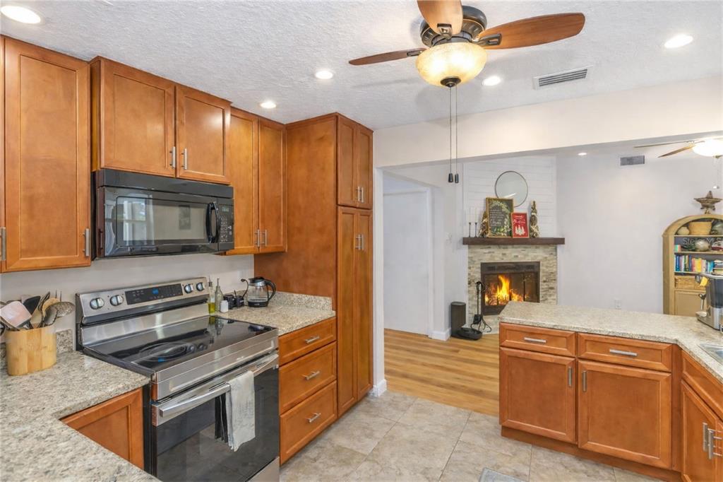 3137 Loblolly Street Deltona, FL 32725 - Photo 7 of 30 a kitchen with stainless steel appliances granite countertop a stove and a sink