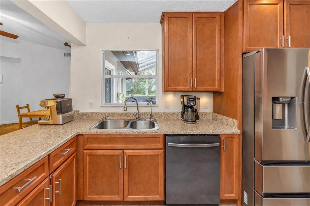 3137 Loblolly Street Deltona, FL 32725 - Photo 9 of 30 a kitchen with stainless steel appliances granite countertop a refrigerator and a sink