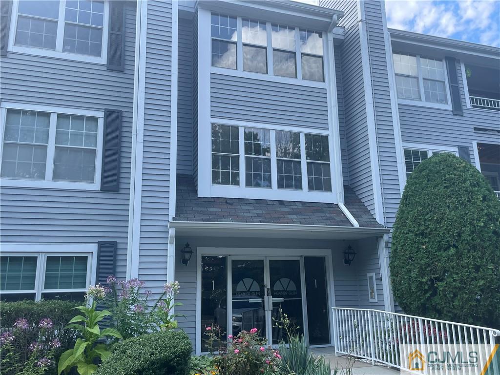 112 Raintree Court Helmetta, NJ 08828 - Photo 1 of 3 a view of brick house with large windows and a yard