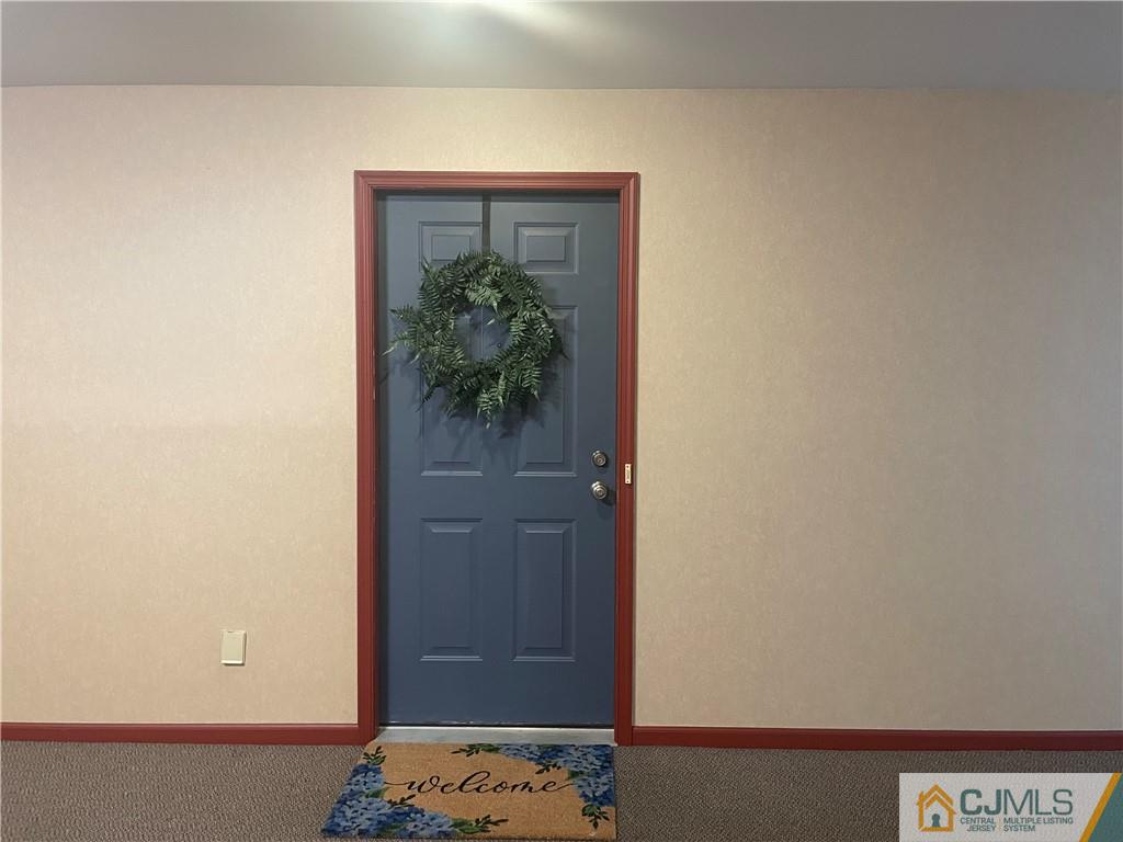 112 Raintree Court Helmetta, NJ 08828 - Photo 2 of 3 a view of hallway with wooden floor
