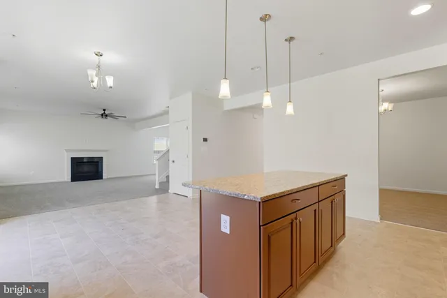 a kitchen with a stove a refrigerator a sink and chandelier