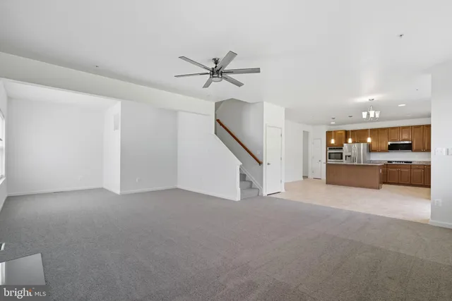 a view of an empty room with a kitchen