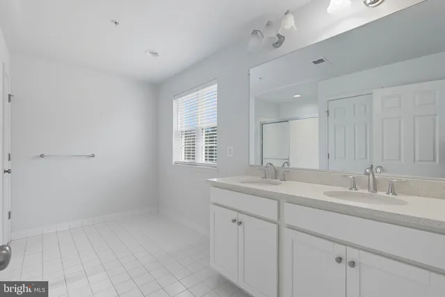 a bathroom with 2 sink tub and a mirror