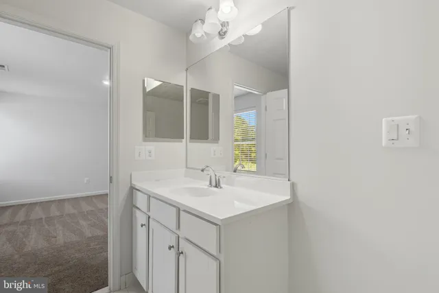 a bathroom with a sink a vanity and mirror