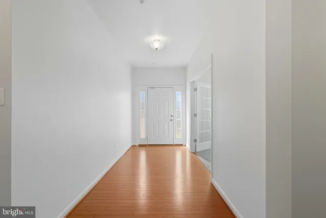 a view of hallway with wooden floor
