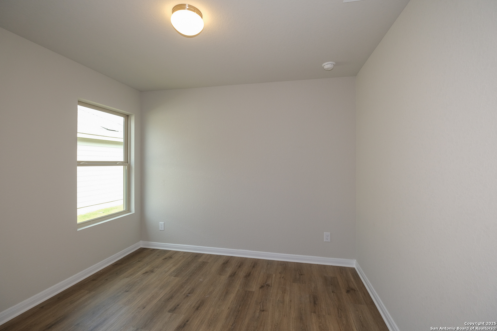 1124 Water Valley Seguin, TX 78155 - Photo 20 of 39 an empty room with wooden floor and windows